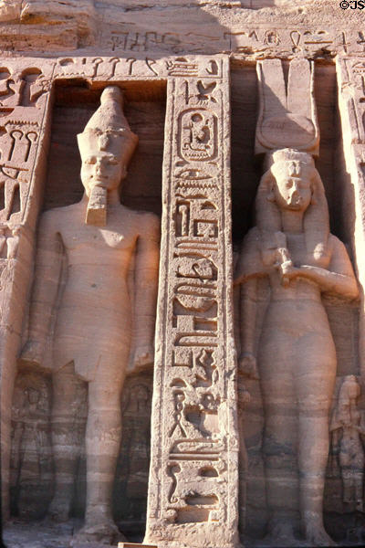 Sculpted Pharaoh & queen with hieroglyphics on Small Temple of Queen Nefertari (13thC BCE) at Abu Simbel. Egypt.