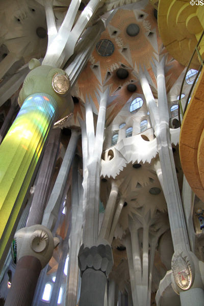 Gaudí column hit by light from stained glass in Sagrada Familia. Barcelona, Spain.