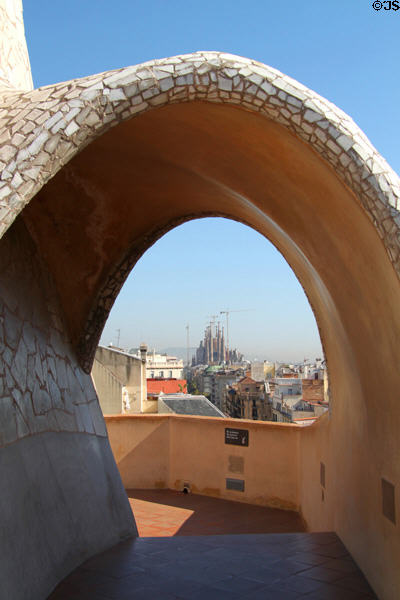 Rooftop vista from Casa Milà with Sagrada Familia in distance. Barcelona, Spain.