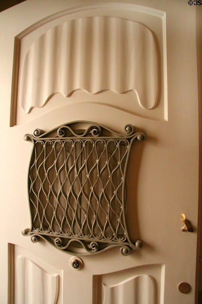 Apartment door with Gaudi style grill at Casa Milà. Barcelona, Spain.
