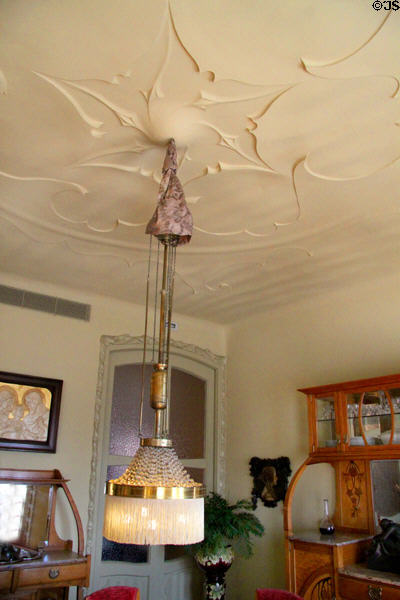 Textured ceiling & chandelier in dining room of museum apartment at Casa Milà. Barcelona, Spain.