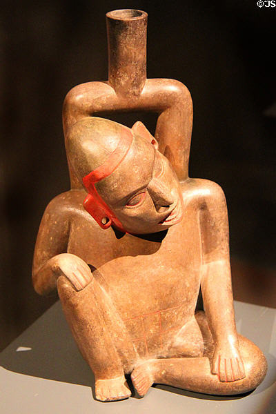 Ceramic stirrup-handle vessel with seated man (900-400 BCE) from Cupisnique Culture, Peru at Barbier Mueller Precolumbian Art Museum. Barcelona, Spain.