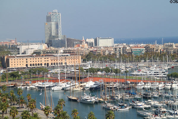 Overview of Marina of Port Vell, brown Museum of Catalonia History & highrises built for Olympic Village beyond. Barcelona, Spain.