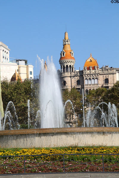 Fountain in Plaça de Catalunya with Casa Antoni Rocamora beyond. Barcelona, Spain.