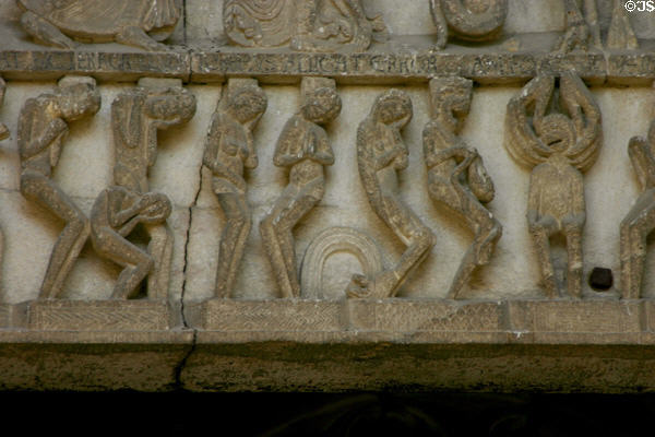 Detail of soles lamenting their fate of Hell at Last Judgment on tympanum of Cathedral St Lazarre. Autun, France.