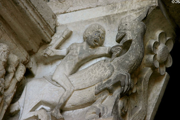 Detail of man fighting mythical animal to left of tympanum of Cathedral St Lazarre. Autun, France.