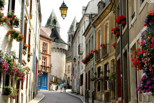 Towers of Rolin Museum & Cathedral at end of flower-lined Petite rue Chauchien. Autun, France.