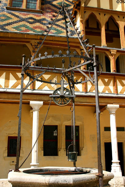 Water well with fine Gothic wrought-iron work in courtyard of Hotel Dieu. Beaune, France.