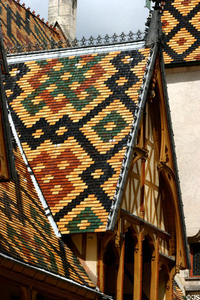 Glazed roof tiles on gable of Hotel Dieu. Beaune, France.