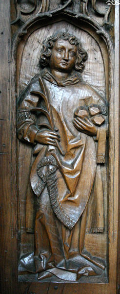 Oak choir stall (1493) carved with St Stephen (with stones of his stoning) in Unterlinden Museum. Colmar, France.