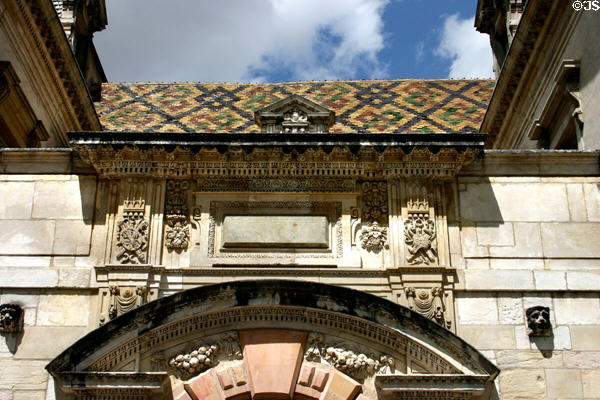 Detail of carvings & tiled roof of Hotel de Vogüé mansion (early 17thC). Dijon, France.