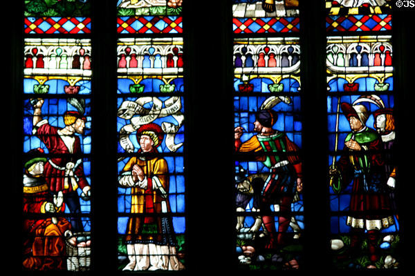 South transept stained glass windows of St Stephen's Cathedral with figures in Medieval dress. Sens, France.