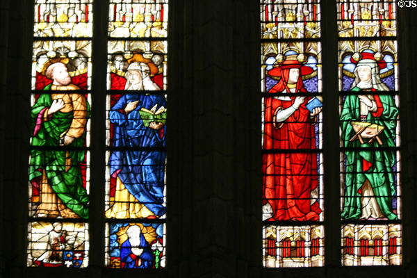 Stained glass window of St Stephen's Cathedral with robed people. Sens, France.