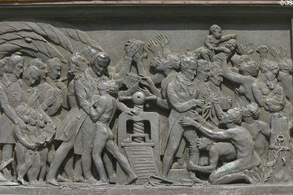 Relief of impact of printing on base of Statue of Guttenberg showing abolition of slavery & writings of Wilberforce, Tomas Clarrion & Condorcet Gregoire. Strasbourg, France.