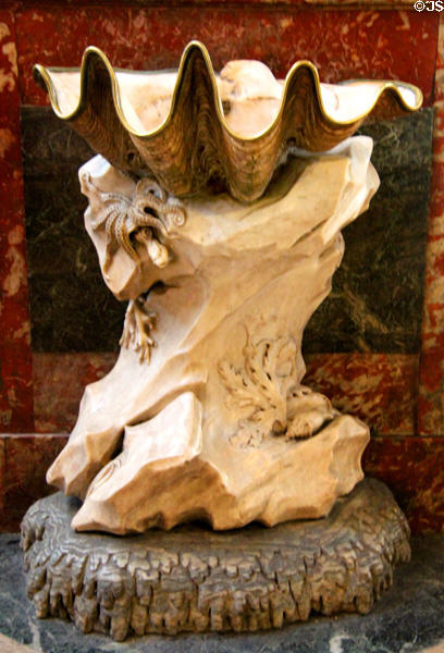 Clam shell holy water font on carved base by Jean-Baptiste Pigalle at St-Sulpice church. Paris, France.