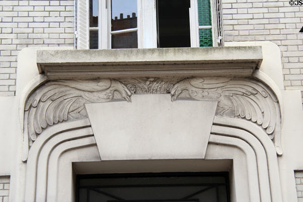 Doorway lintel carved with pair of roosters at Montmartre. Paris, France.