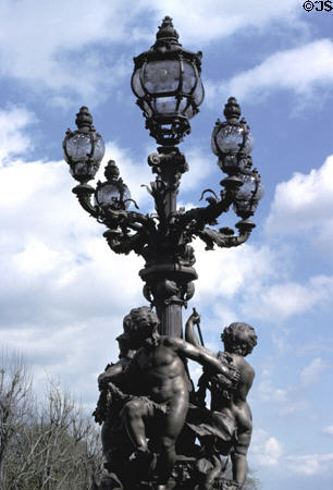 Iron lamppost with cherubs on Alexandre III bridge. Paris, France.