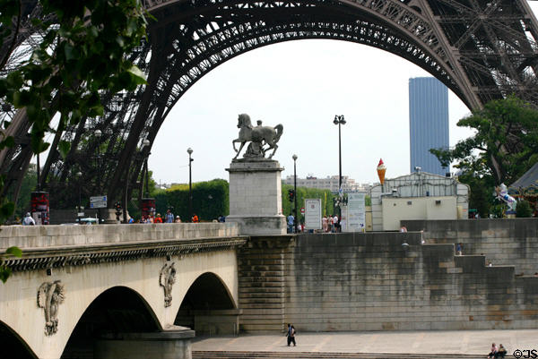 Roman warrior statue (1853) by Louis-Joseph Daumas on Pont d'Iéna (1814) with Eiffel Tower beyond. Paris, France.