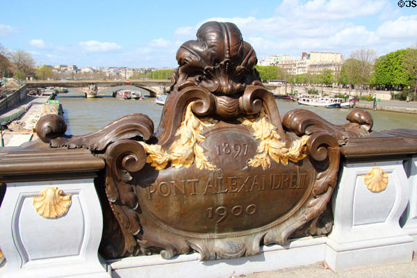 Art Nouveau plaque with bridge name midway on Pont Alexandre III. Paris, France.