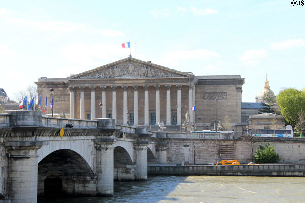 National Assembly part of French Parliament meets in former Palais Bourbon (1722-8) seen from Place de la Concorde across River Seine. Paris, France.