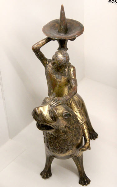 Bronze candle stick as woman riding lion (end 12thC) from Meuse Valley at Museum of Decorative Arts. Paris, France.