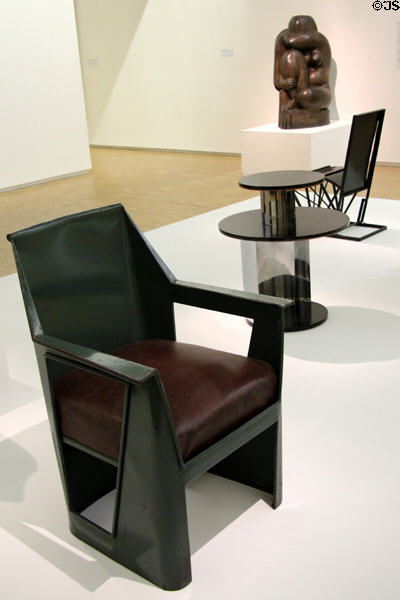 Armchair with simulated leather seat c1930 by René Prou with 1930s pedestal table, garden chair & sculpture at Georges Pompidou Center. Paris, France.