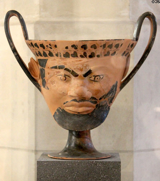 Greek terracotta Kantharos (vase for drinking wine) (c540 BCE) depicting satyr head from Miletus at Louvre Museum. Paris, France.