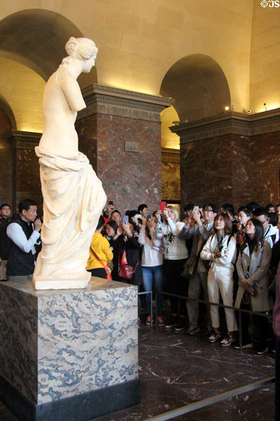 Crowds around Aphrodite aka "Venus de Milo" (100 BCE) at Louvre Museum. Paris, France.