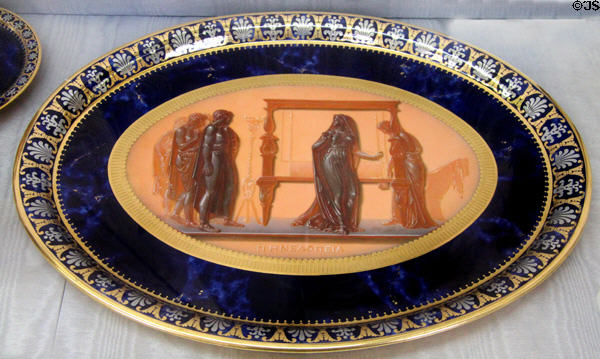 Sèvres porcelain plate imitating antique cameo of Penelope caught unwinding her weaving in the Odyssey (1813-5) by Jean-Marie Degault at Sèvres National Ceramic Museum. Paris, France.