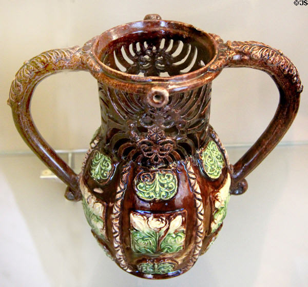 Glazed earthenware puzzle jug (17thC) from Saintonge, France at Sèvres National Ceramic Museum. Paris, France.