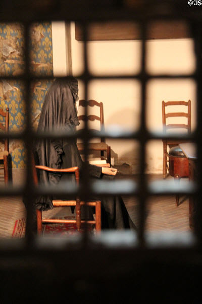Reproduction of the 1793 cell of Marie-Antoinette as seen through bars with period furniture at Conciergerie. Paris, France.