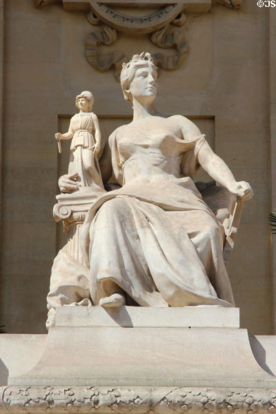 Seated figure with Athena sculpted on Grand Palais. Paris, France.