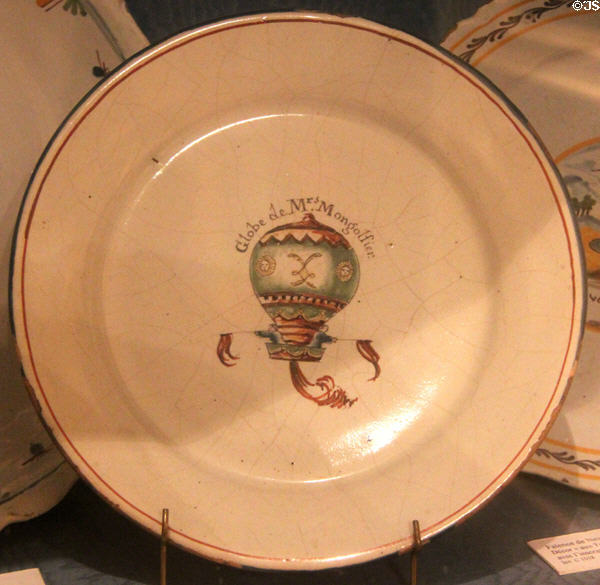 Earthenware plate with Mongolfier emblem commemorating first human balloon free flight by Pilâtre de Rozier & Marquis d'Arlandes in 1783, made by Faïence de Desvres at Carnavalet Museum. Paris, France.