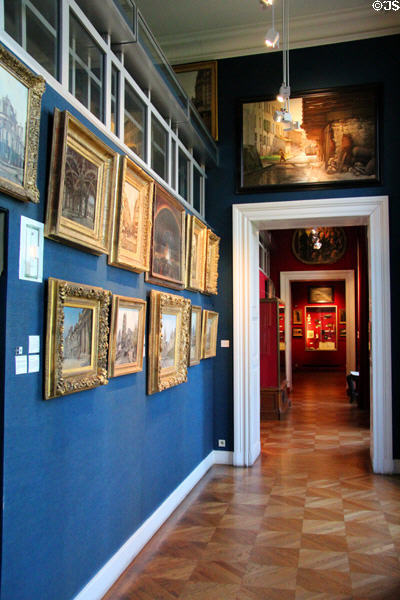Wall lined with paintings of Paris at Carnavalet Museum. Paris, France.