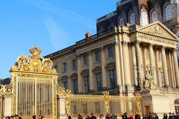 Northern chapel wing of Versailles Palace flanking Royal Court closed off by gilded gates. Versailles, France.