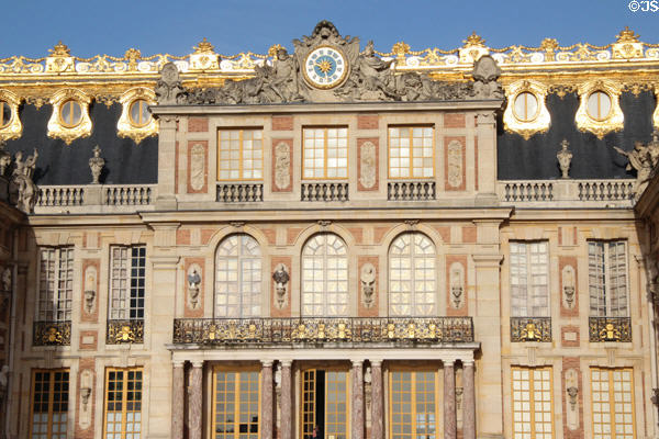 Clock & facade of Marble Court of first Versailles Palace. Versailles, France.