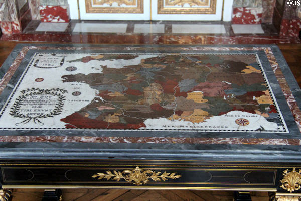 Map of France (1684) inlaid stone tabletop as given to king in salon of abundance at Versailles Palace. Versailles, France.