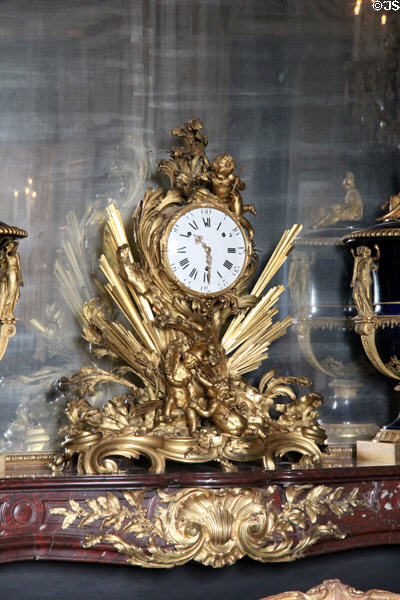 Clock to glory of Louis XIV (1754) by clockmaker Martinot & bronze craftsman Gallien in Council Study at Versailles Palace. Versailles, France.