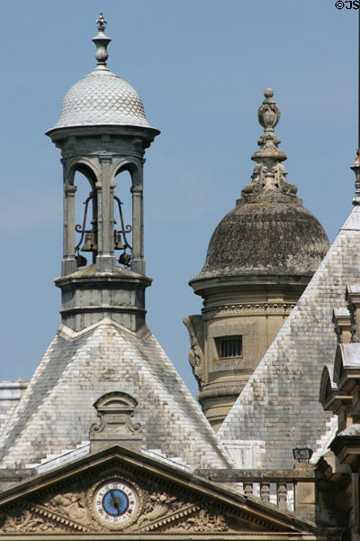 Clock tower with bell-shaped spire at Château de Chantilly. Chantilly, France.