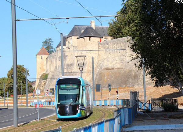 Trolley passes Caen Castle. Caen, France.