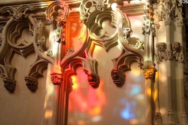 Sunlight through stained glass on ornate carving in St Hubert's Chapel at Chateau Royal of Amboise. Amboise, France.