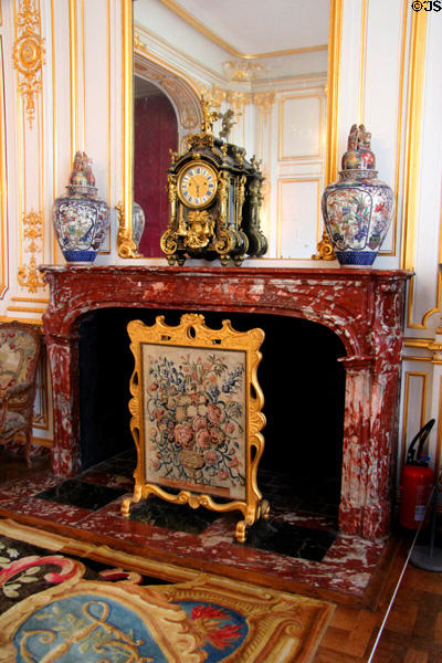 Fireplace with fire screen in new state apartments bedroom at Chambord Chateau. Chambord, France.
