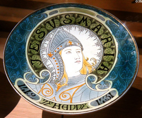 Joan of Arc as warrior in helmet painted on plate (1899) by Lucien Marchal of Earthenware of Lunéville in Royal Lodgings museum at Château de Chinon. Chinon, France.