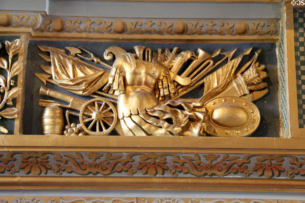 Carved relief of arms & armor in dining room at Cheverny Chateau. Cheverny, France.