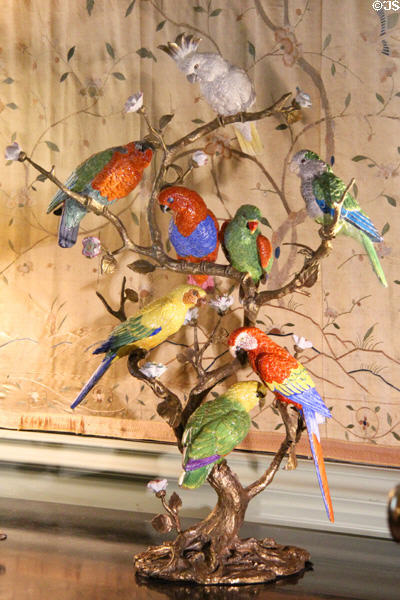 Branch with 8 porcelain parrots upstairs at Cheverny Chateau. Cheverny, France.