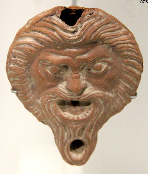 Roman terracotta oil lamp with theater mask of satyr (1st-2ndC) at Musée de la Romanité. Nimes, France.