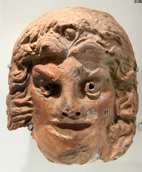 Roman terracotta roof antefix with comedic theater mask (1st-4thC) at Musée de la Romanité. Nimes, France.