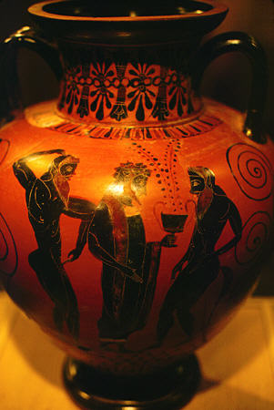 Black figure amphora circa 540 to 530 BC featuring Dionysos flanked by two Satyrs from Cycladic Art Museum, Athens. Greece.