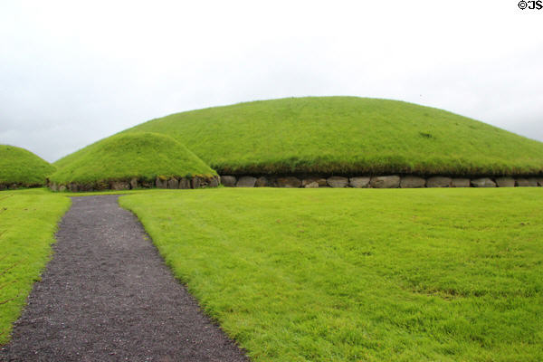 Main Neolithic passage grave (c3200 BCE) & two of 17 smaller satellite tombs at Knowth. Ireland.