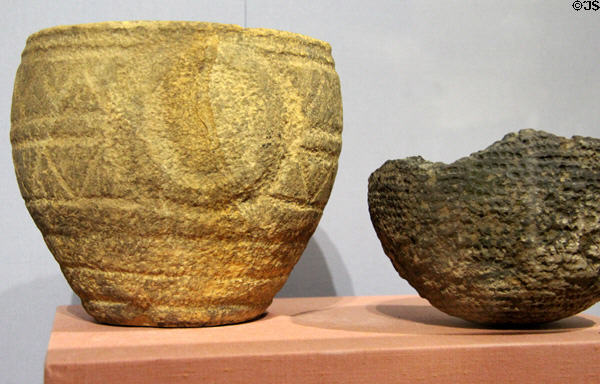 Megalithic decorated vessels (3300-2800 BCE) of stone from tomb in Knowth & pottery from settlement in Bracklin at National Museum of Ireland Archaeology. Dublin, Ireland.
